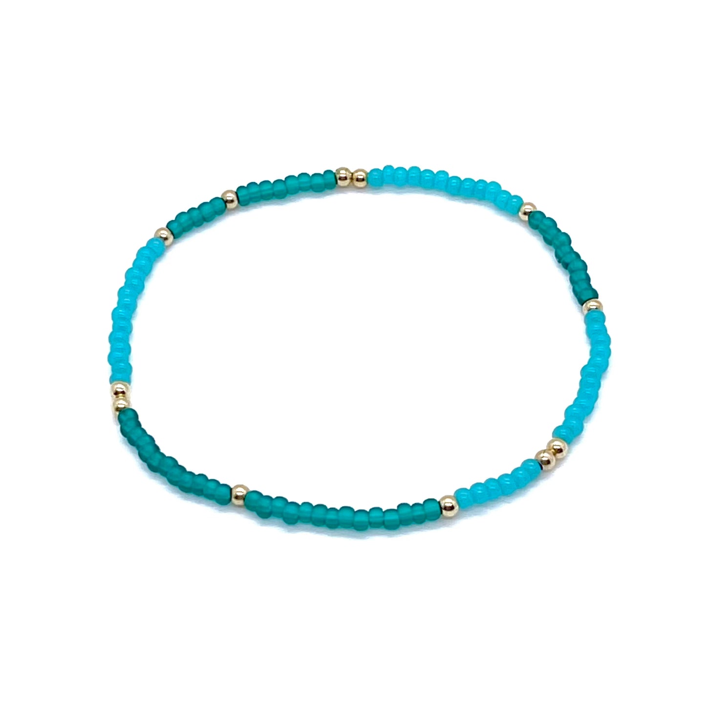 Gold ball ankle bracelet with green and turquoise colored seed beads. Stretchy anklet handmade in NYC.