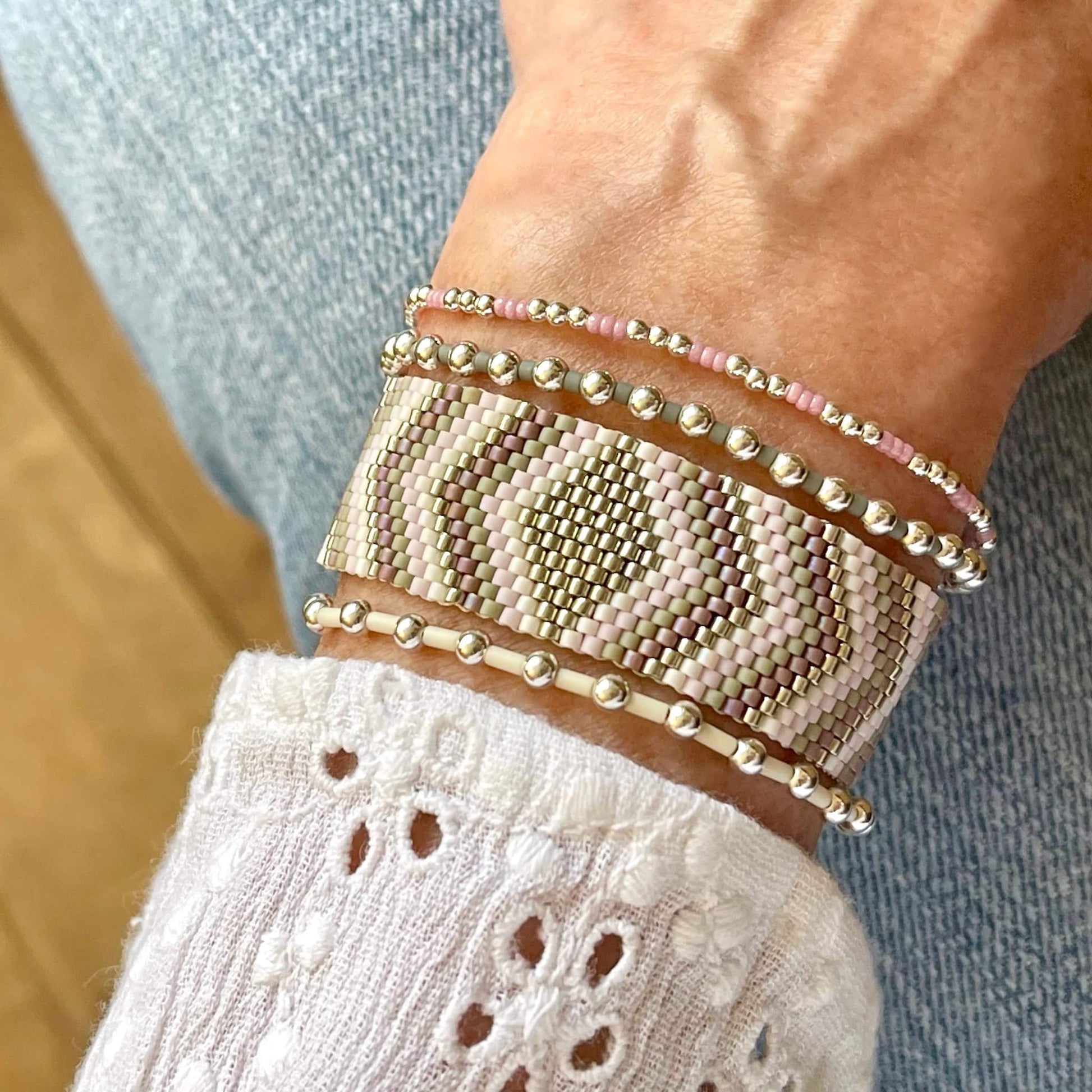 Flat beaded bracelet in silver, mauve, lavender, and gray diamond and chevron peyote pattern, with 2 sterling and glass bead stretch bracelets.
