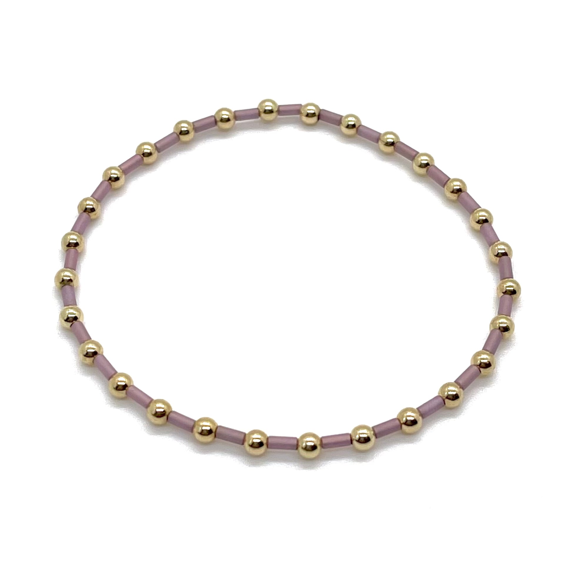 3mm gold filled bracelet with mauve bugle seed beads on elastic stretch cord.