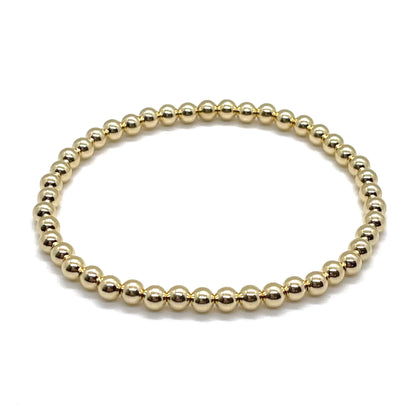 4mm 14K gold filled ball bracelet on elastic stretch cord. Non tarnishing and waterproof.