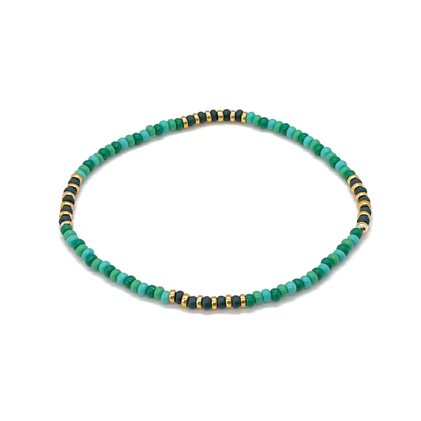 Beaded ankle bracelet with various green seed beads and gold tone accent beads. Fun summer stretch ankle bracelet.