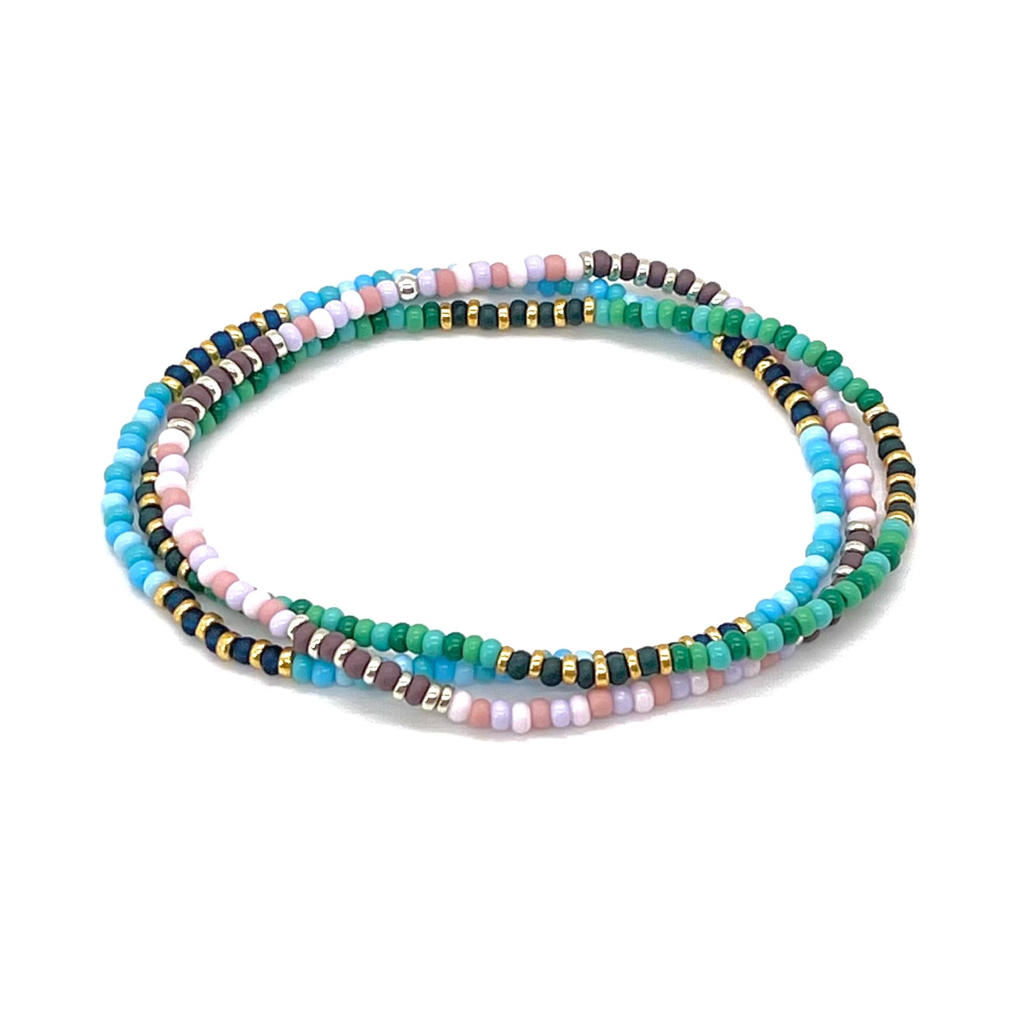 Beaded ankle bracelets with pink, blue and green seed beads and gold and silver tone accent beads on elastic.