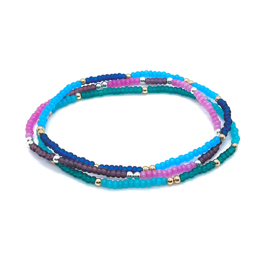Beaded anklets with bright two-tone color bars in blue, green, pink and purple with silver and gold fill balls.