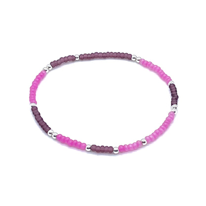 Beaded anklet with hot pink and purple seed beads and sterling silver beads on stretch cord.