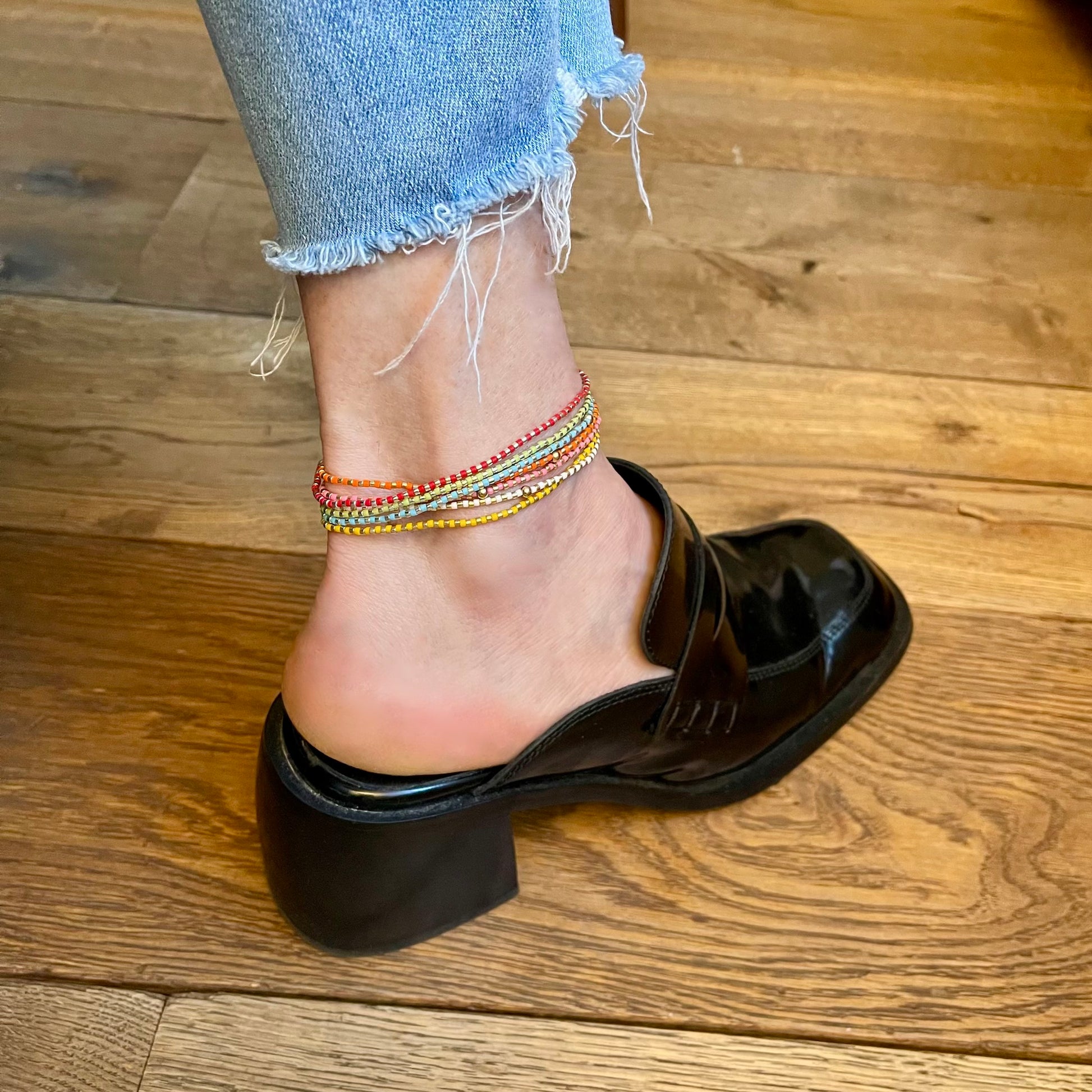 Dainty anklets on stretch cord. Fun, colorful skinny ankle bracelets in assorted colors.