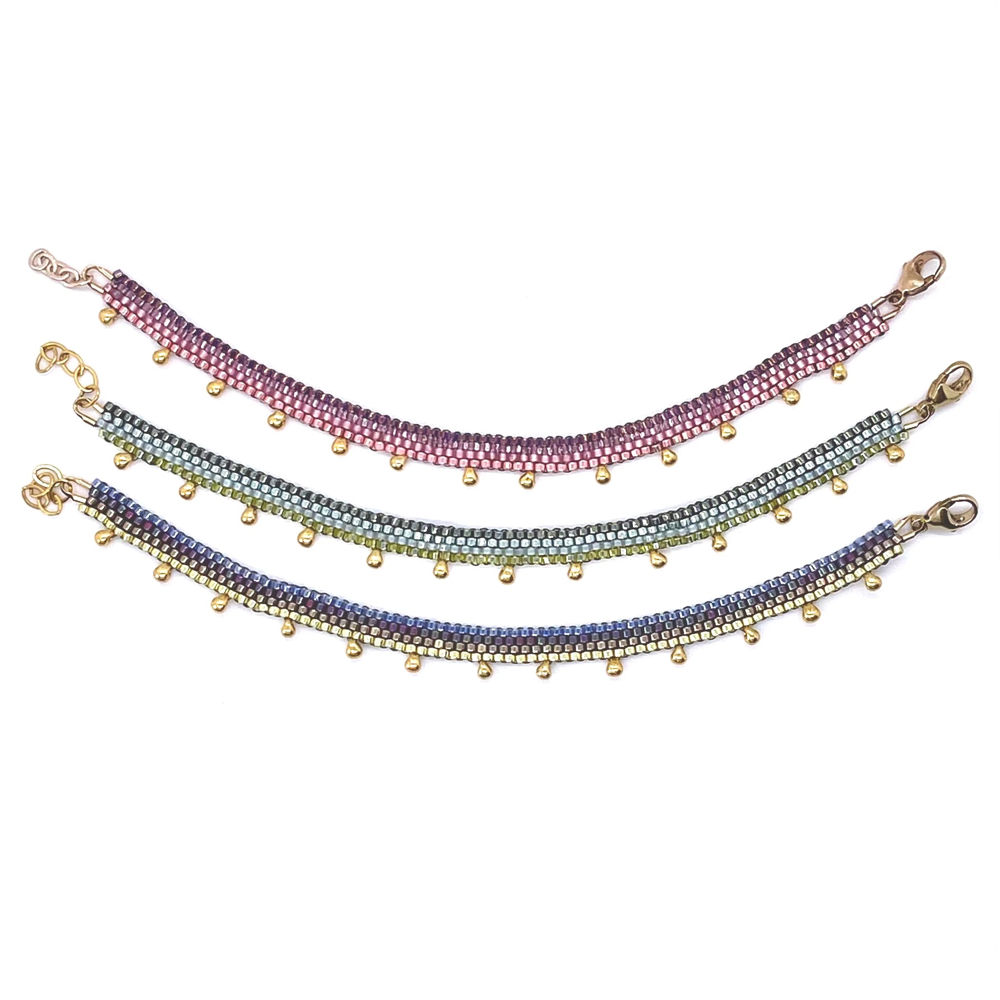 Metallic seed bead anklets with gold drop beads and pink, green, purple and blue stripes. Peyote stitch handwoven in NYC. 