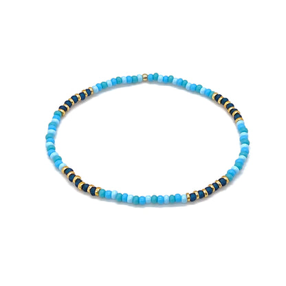 Seed bead anklet with blue and gold tone seed beads. Cute handmade summer stretch ankle bracelet.