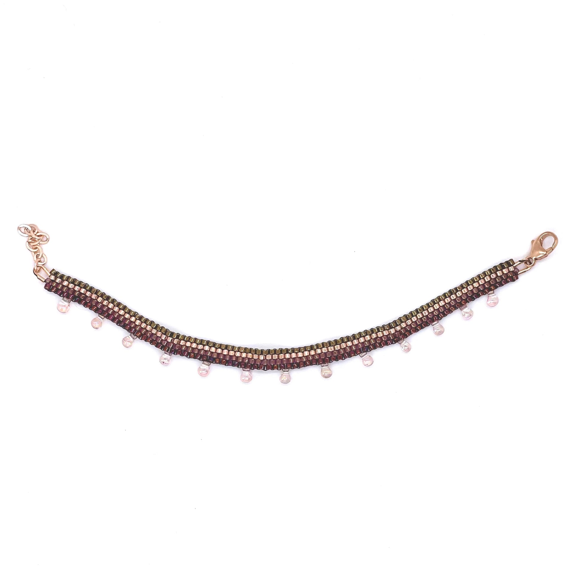 Woven ankle bracelet with berry and bronze/gold-tone seed beads and pale pink iridescent droplet beads.
