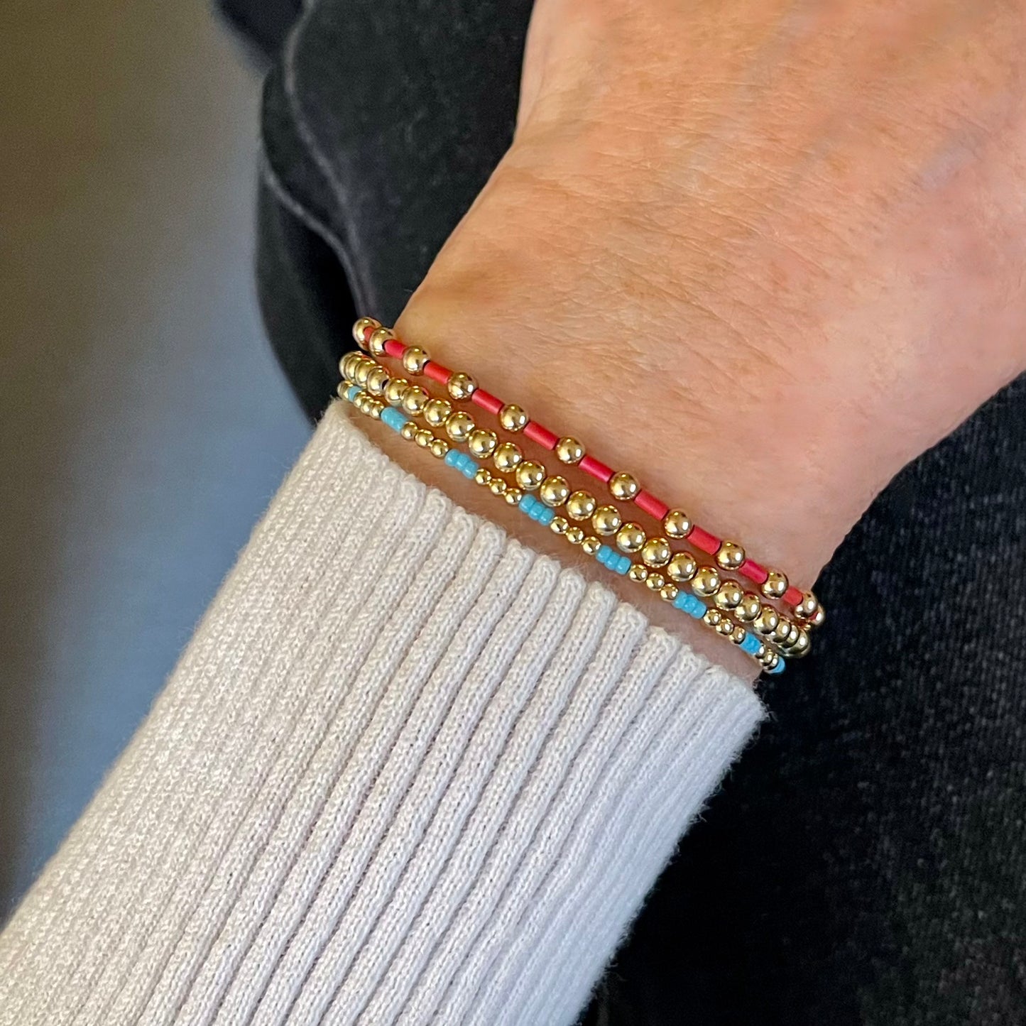 Bead bracelets with 14K gold filled beads and red and light blue seed beads. Dainty stretch bracelet stack of 3.