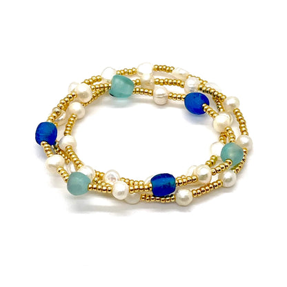 Blue and pearl bracelets with sea glass, freshwater pearls, and gold tone seed beads.