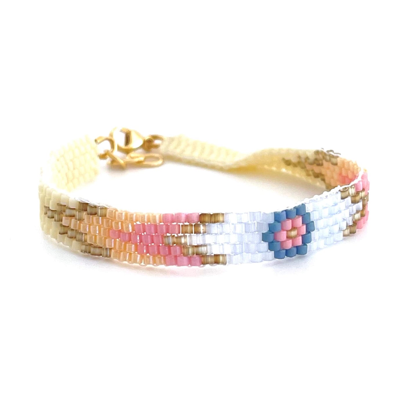 Light blue bracelet with pink and peach arrow  pattern. Flat beaded bracelet handmade in NYC using a peyote stitch.