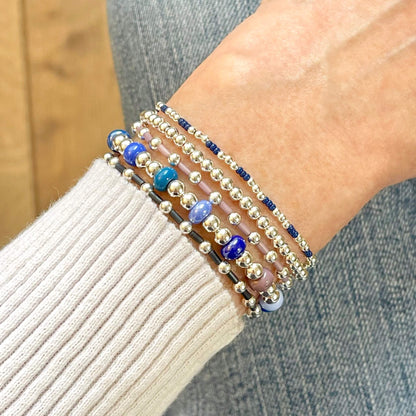 Set of 5 Monochromatic Beaded Stretch Bracelets in Silver and Shades of Blue & Plum.