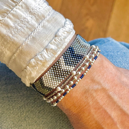 Blue and silver chevron beaded bracelet with 3 stretch bracelets. Seed beads, pearl beads, and sterling silver beads.