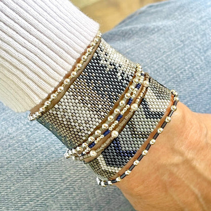 Silver Bead Bracelets and Flat Beaded Bracelets. Stackable beaded bracelets with blue and gray seed beads.