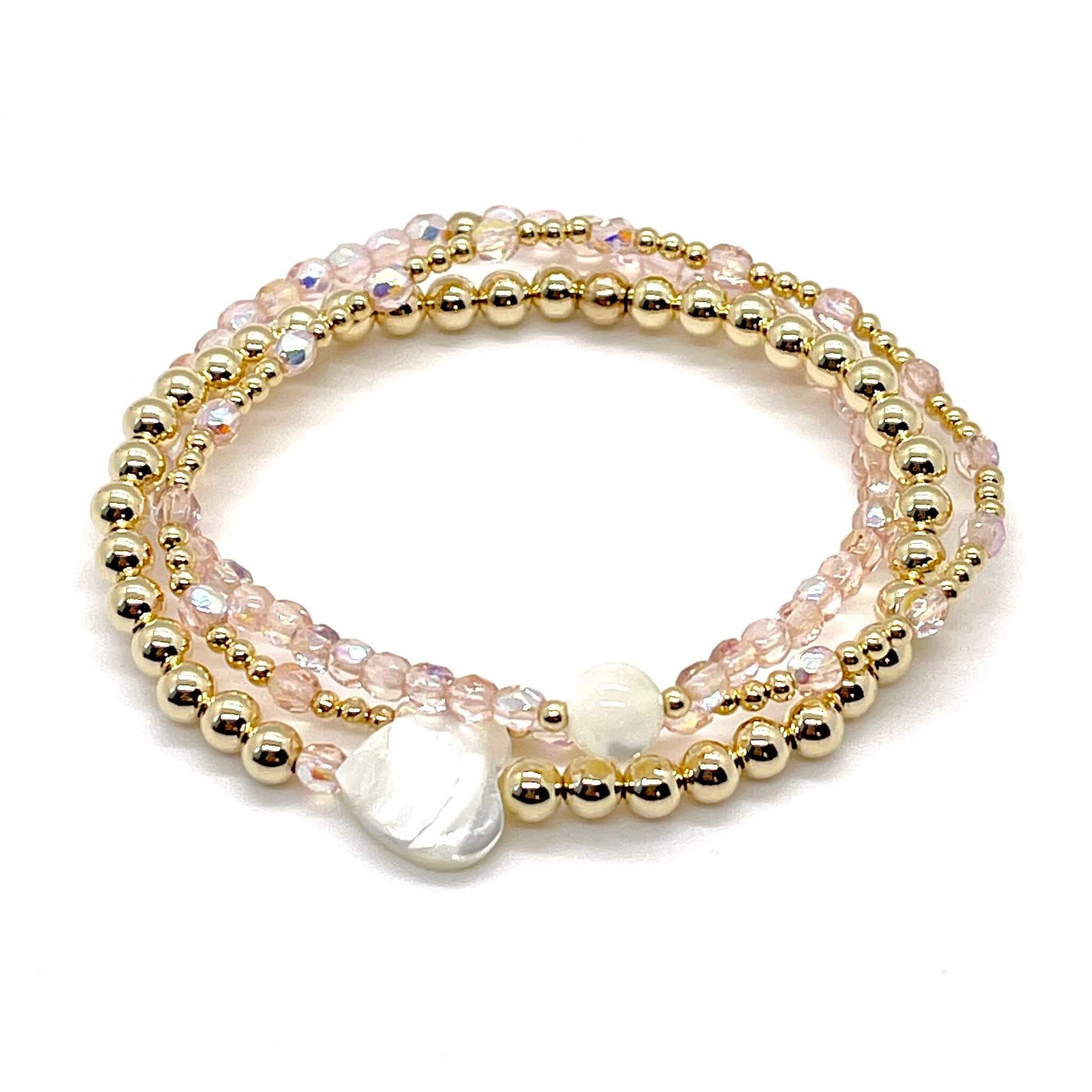 Blush-rose crystal and gold bracelet stack of 3. Womens handmade stretch bracelets wtih round and heart shaped mother-of-pearl accent beads.