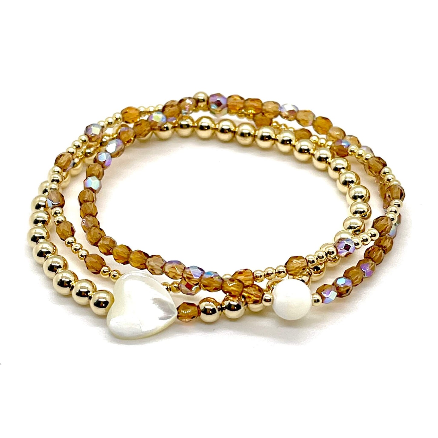 Bridesmaid bracelet gift. Amber crystals, 14K gold filled beads, and heart and round mother-of-pearl beads on elastic stretch cord.