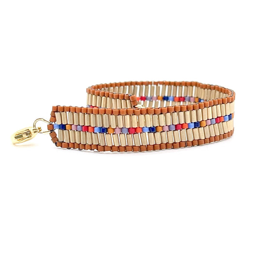 Southwestern inspired colorful bead woven bracelet with matte gold bugle beads. A modern boho everyday bracelet with an edge.