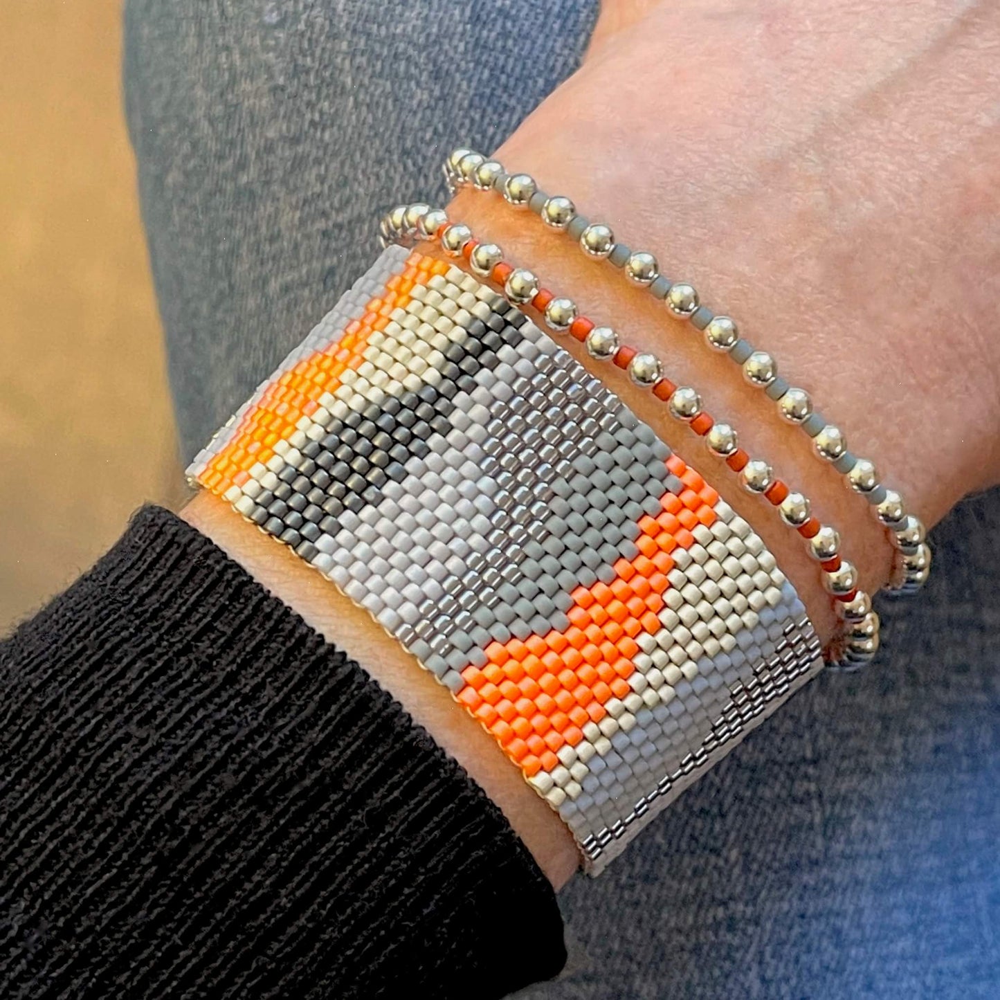 Camouflage orange and gray stack with beaded woven band and stretch bracelets with sterling silver and colorful beads.