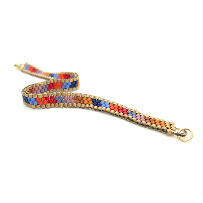 Candystripe bracelet with red, blue, and gold southwest hues seed bead mix.