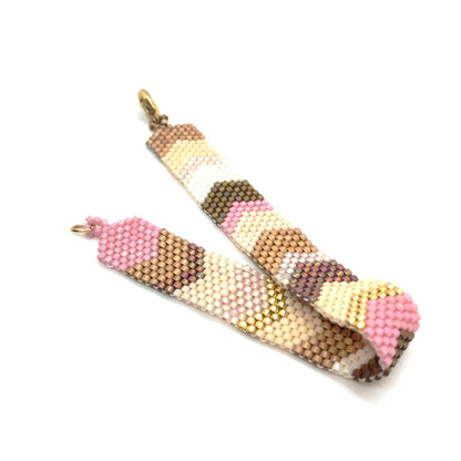 Chevron bracelet band with pink, gold, and ivory seed beads in a peyote stitched chevron motif. Handmade without a loom.