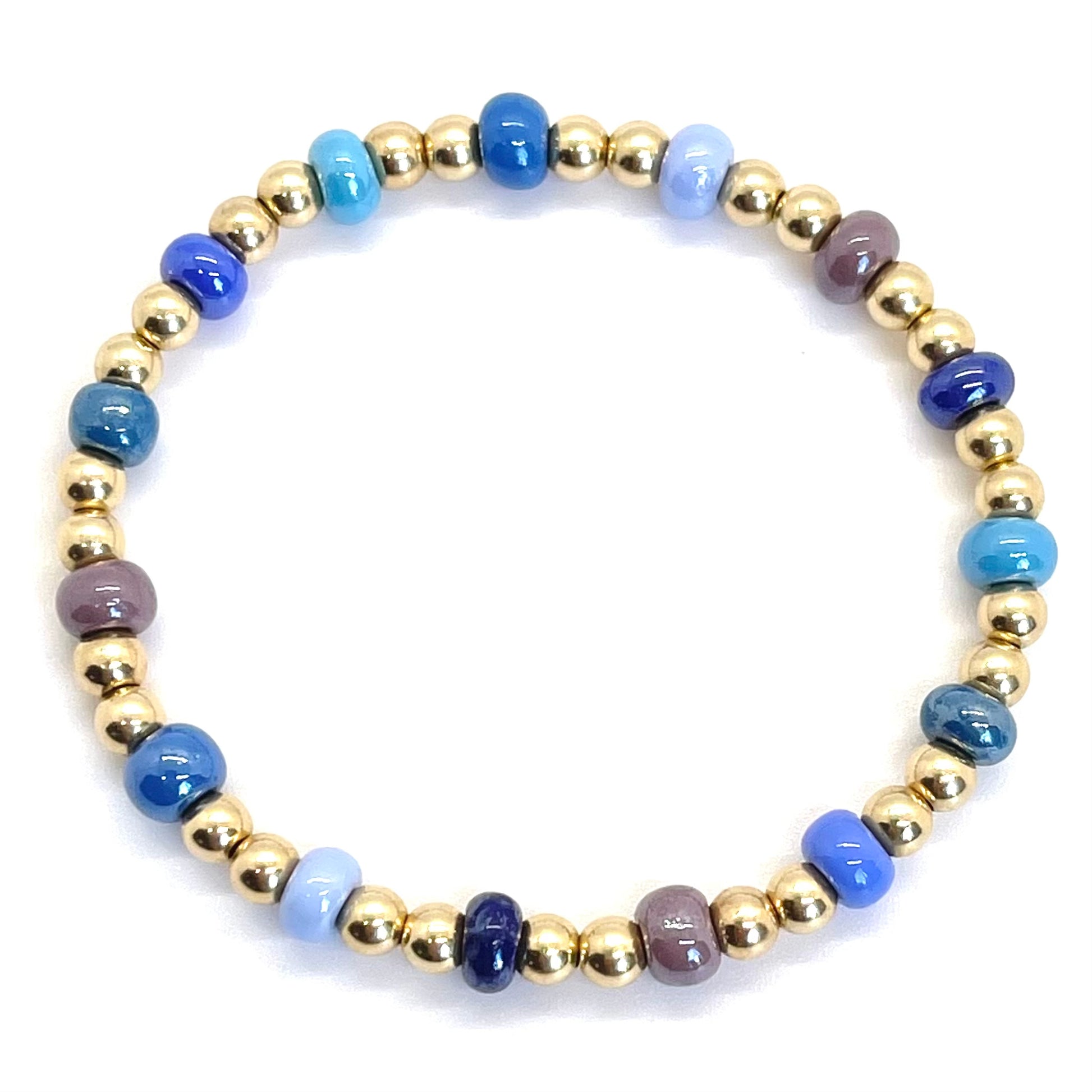 Colorful beaded bracelet with large glass beads in monochromatic shades of blue and 4mm 14K gold filled beads on elastic stretch cord.