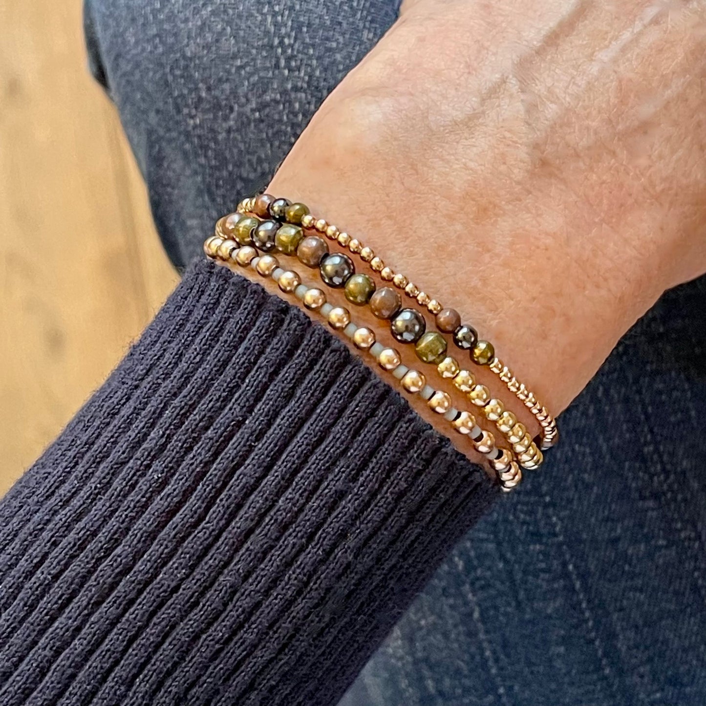 Copper, brass, and gunmetal mixed metal stretch bracelet stack with 14K yellow and rose gold filled beads and seed beads.
