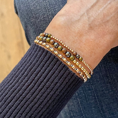 Copper, brass, and gunmetal mixed metal stretch bracelet stack with 14K yellow and rose gold filled beads and seed beads.