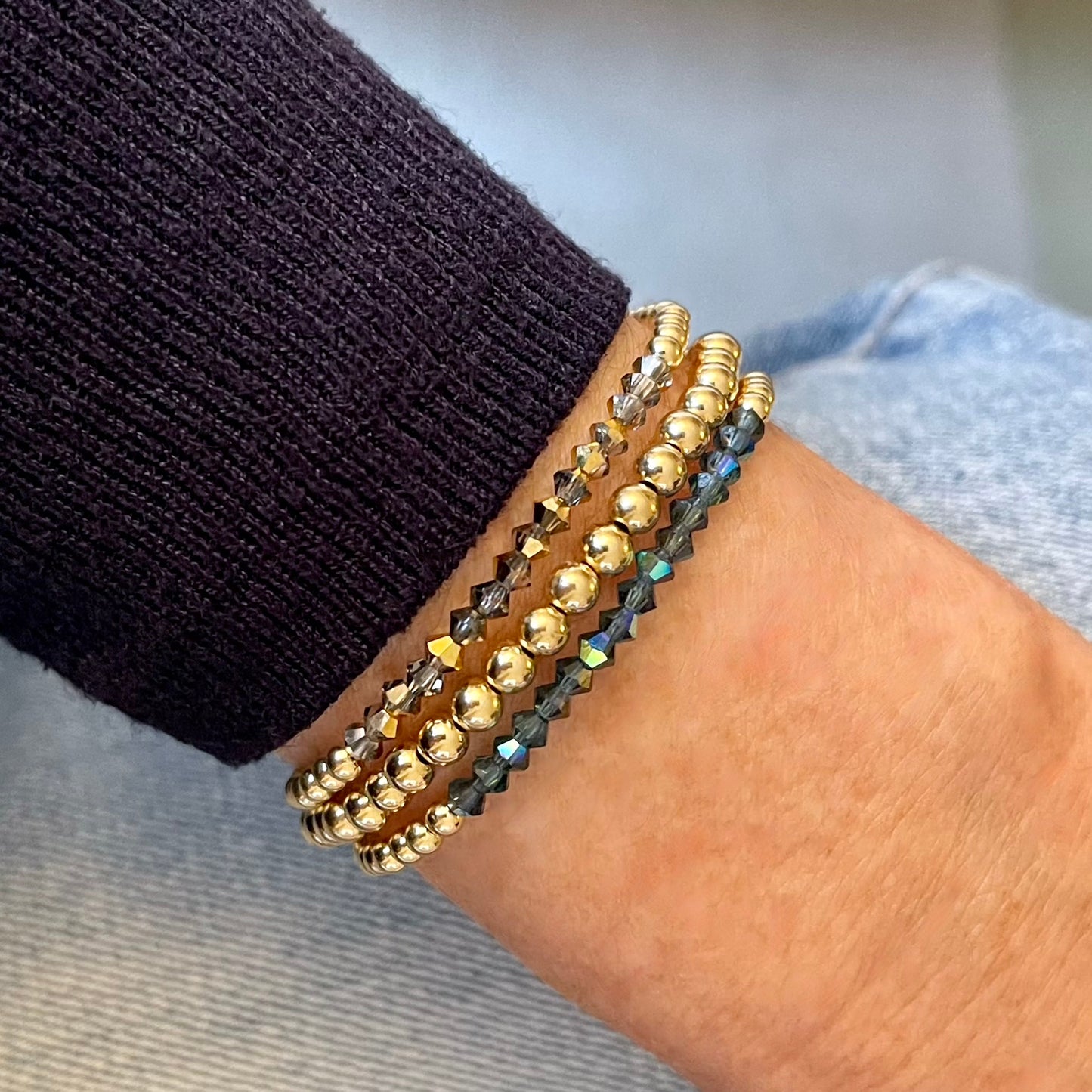 Crystal bead bracelets in grey and blue with 14K gold-filled 3mm and 4mm gold beads on stretch cord.