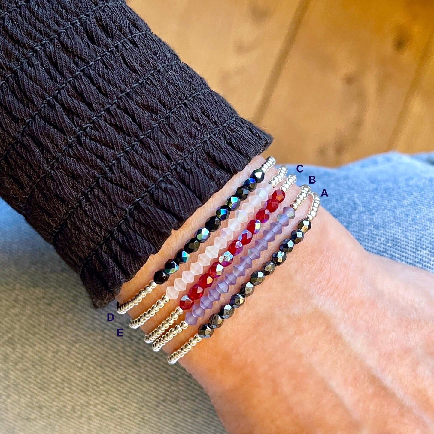 Silver beaded stretch bracelets with crystal section in a choice of hematite, lavender, red, white, or black beads.