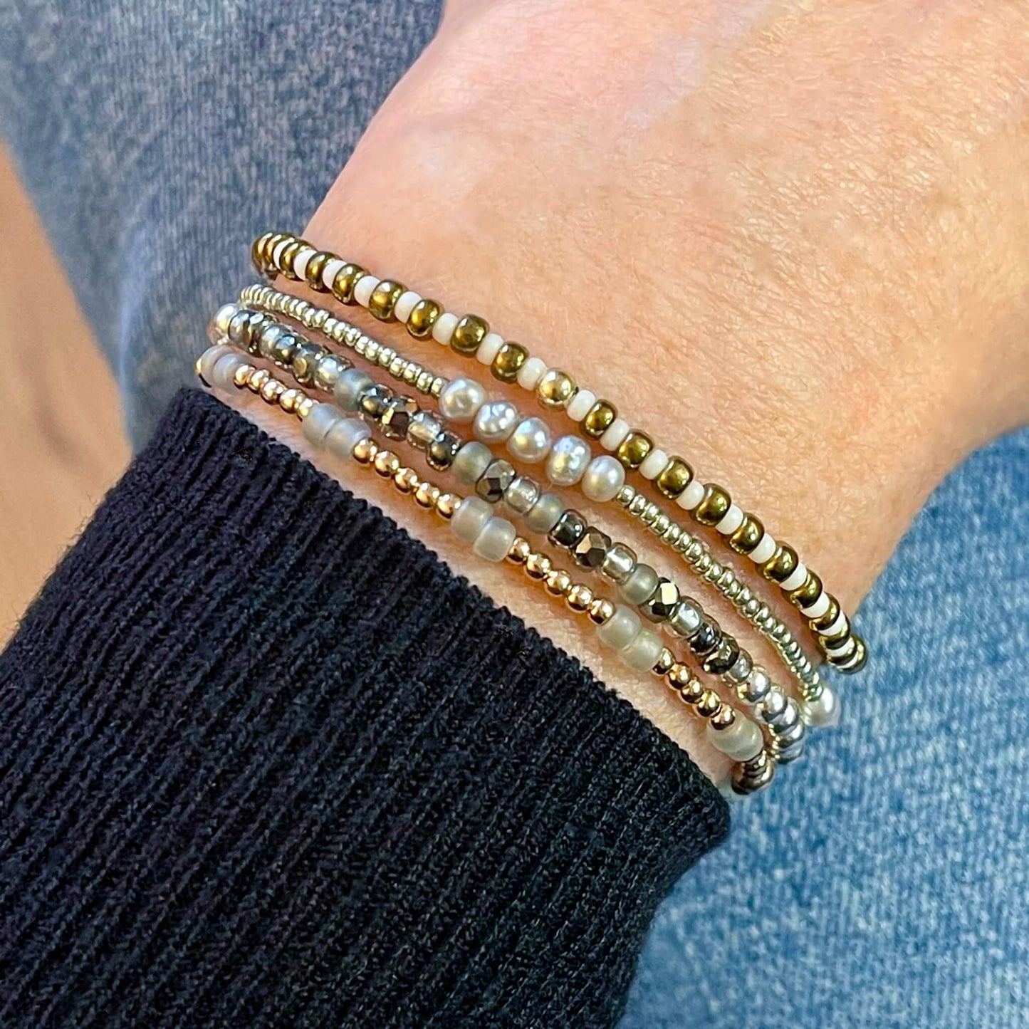 Dainty mixed metals beaded stretch bracelet stack of 4 with rose gold fill beads, freshwater pearls, and metal-tone glass seed beads.