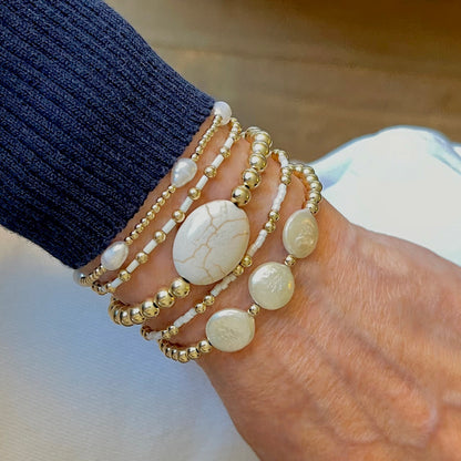 Freshwater pearl bracelets with gold ball beads,  magnesite, and white seed beads on elastic stretch cord.