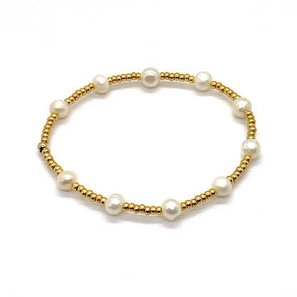 Freshwater pearl gold bracelet with rondelle pearls and gold tone glass seed beads.