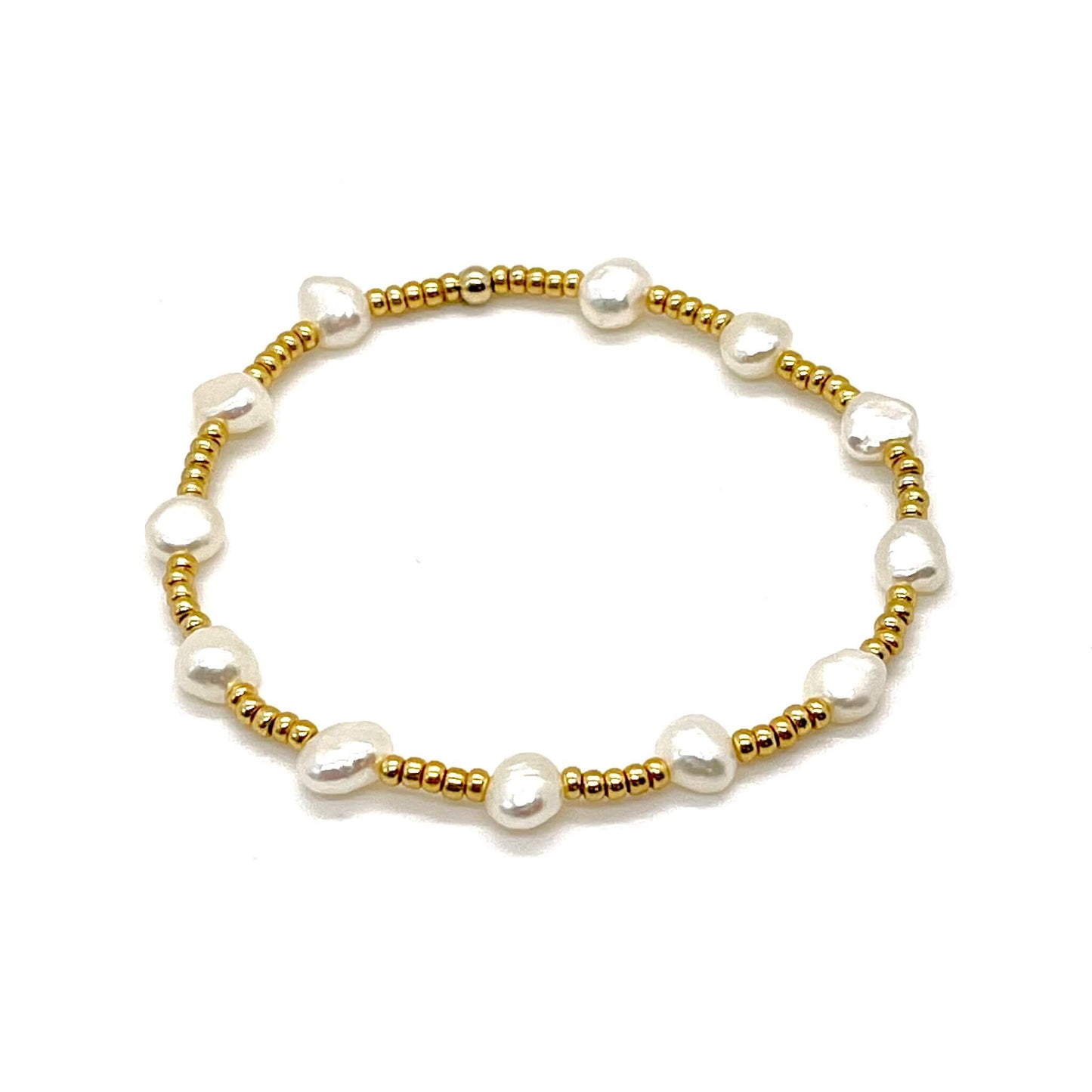 Freshwater pearl stretch bracelet with flat bottom pearls and small gold tone glass seed beads.