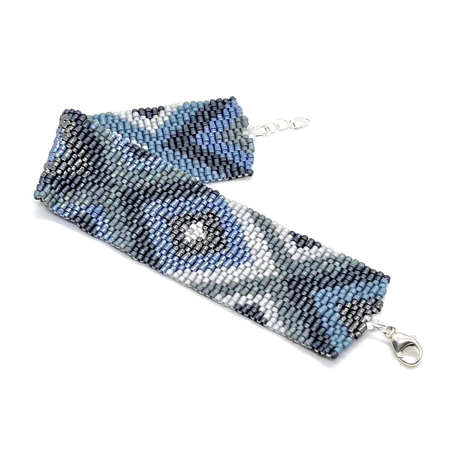 Blue, gray, and silver, wide seed bead bracelet cuff with a modern Xs and diamonds geometric pattern.