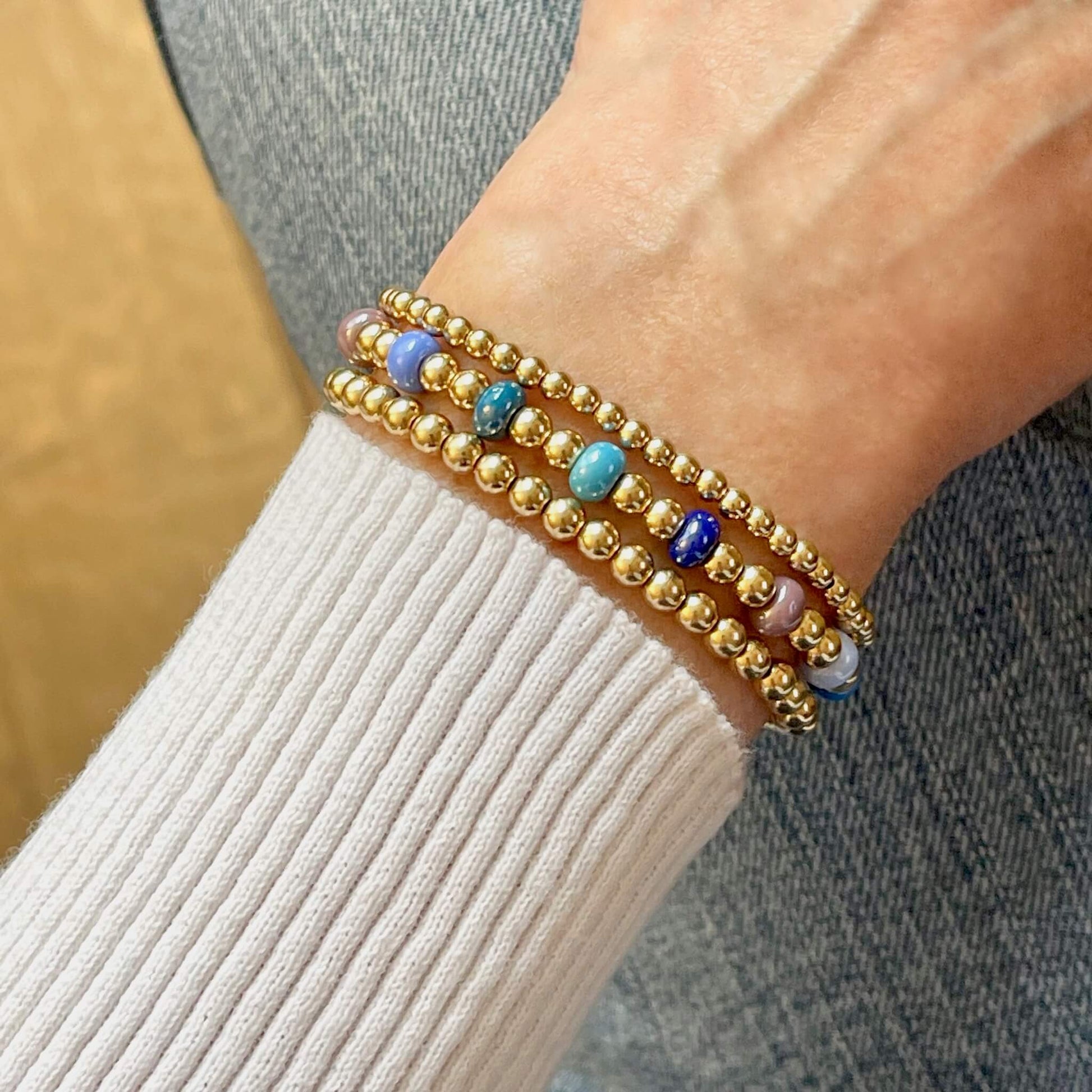 Set of 3 Monochromatic Beaded Stretch Bracelets in Gold and Shades of Blue & Plum.