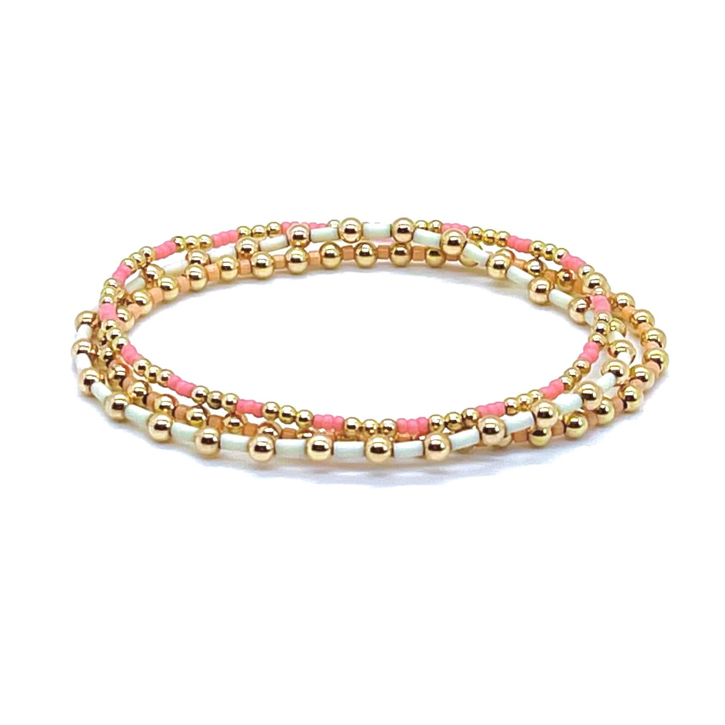 Gold filled bracelets with pink, white, and peach seed beads. Bracelet stack of 3 stretch bracelets.