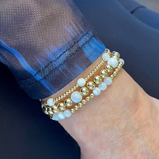 Gold bracelets for bridesmaids with pearls.