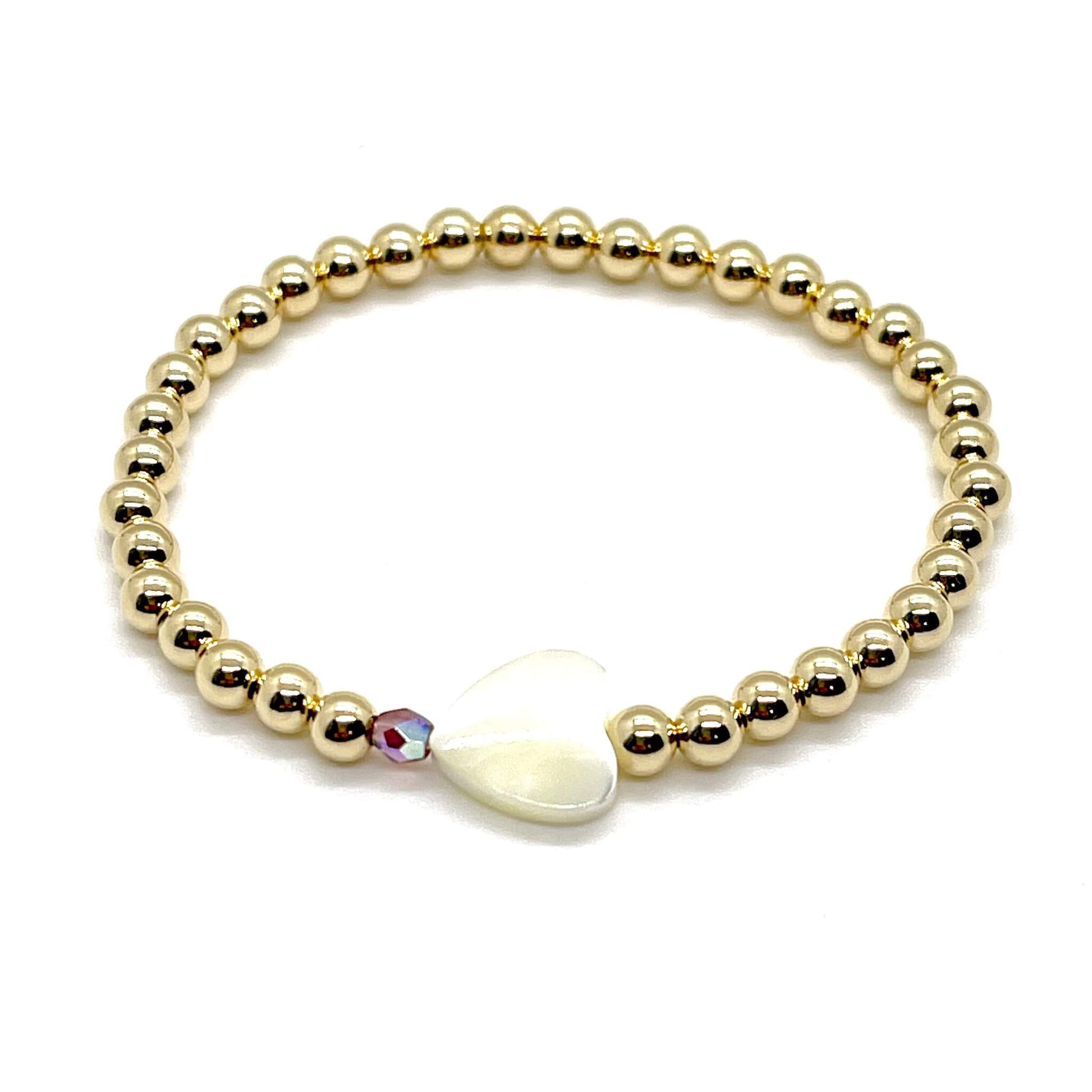 Gold heart bracelet with a mother-of-pearl heart, a small faceted amethyst crystal, and 4mm 14K gold filled beads.