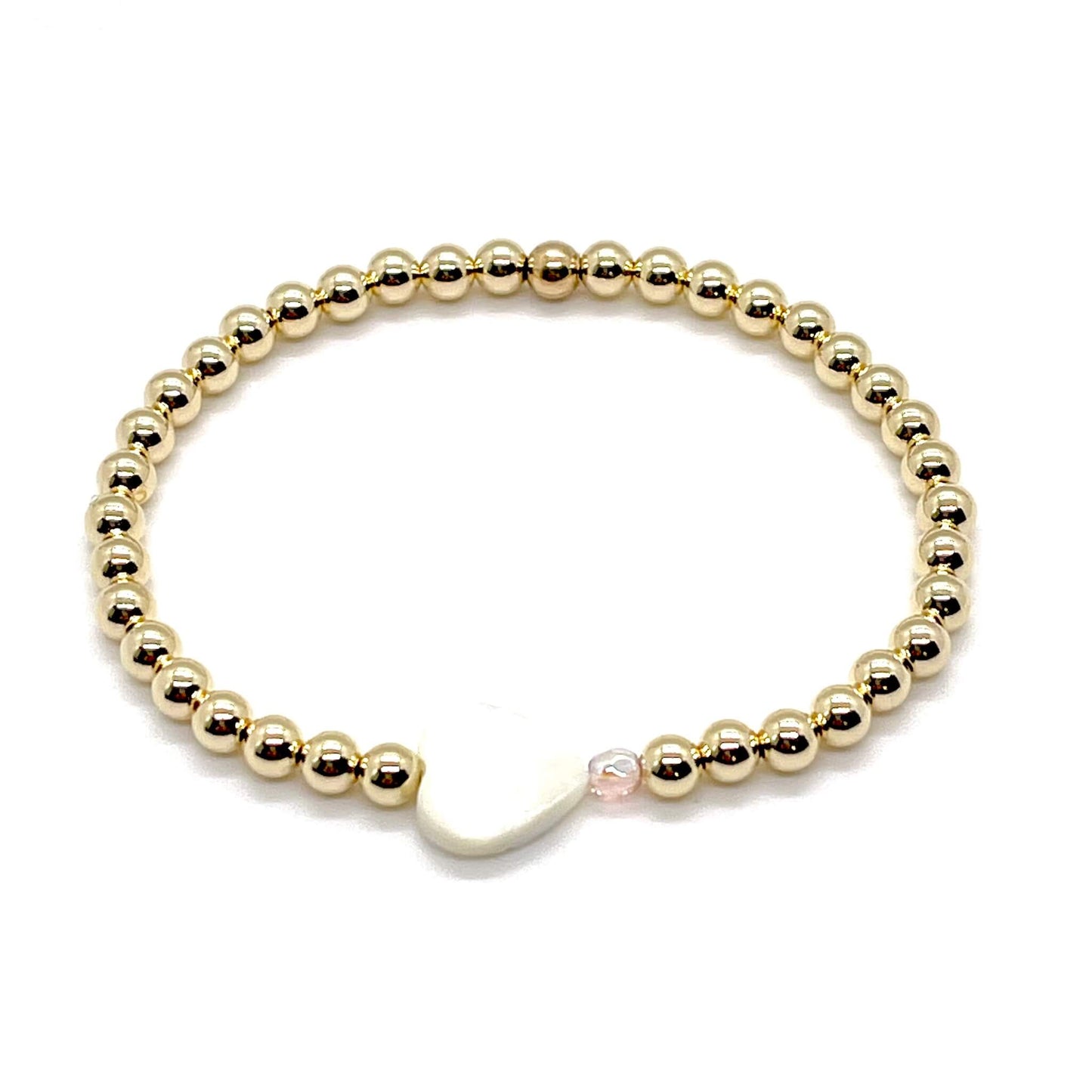 Gold heart bracelet with a mother-of-pearl heart, a small faceted blush-rose crystal, and 4mm 14K gold filled beads.