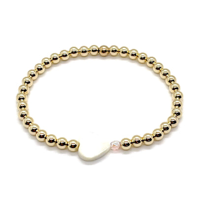 Gold heart bracelet with a mother-of-pearl heart, a small faceted blush-rose crystal, and 4mm 14K gold filled beads.
