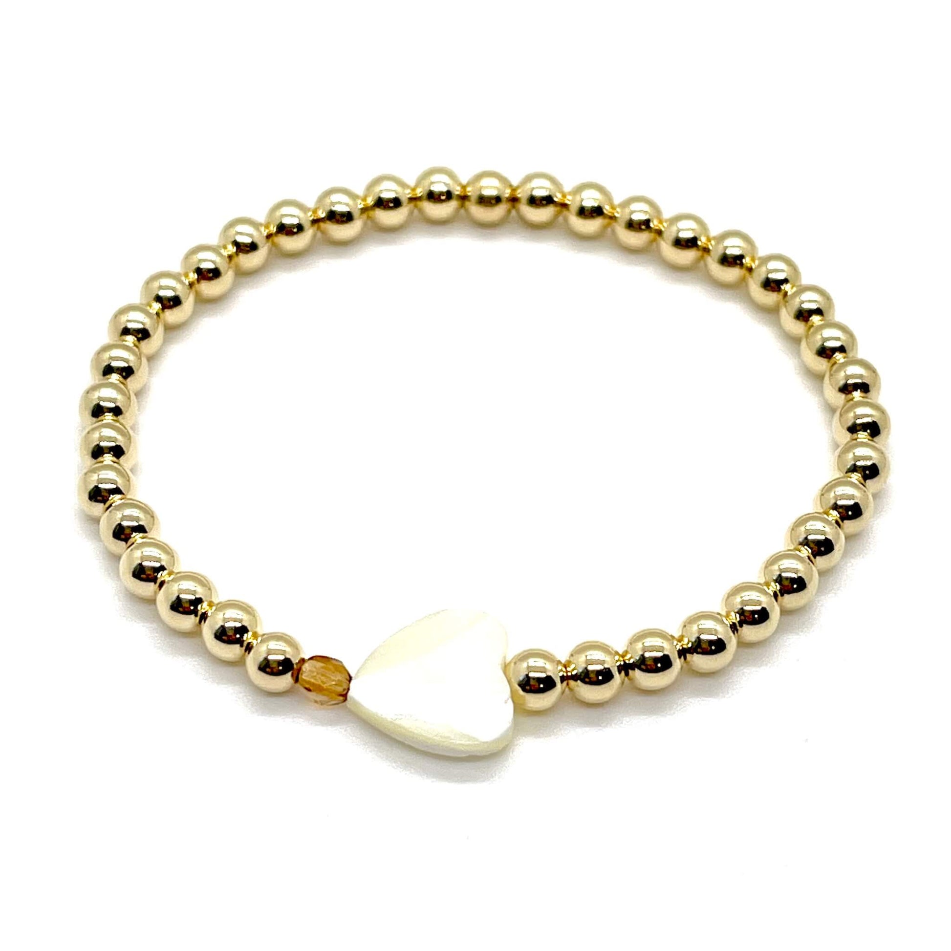 Gold heart bracelet with a mother-of-pearl heart, a small faceted brown topaz crystal, and 4mm 14K gold filled beads.