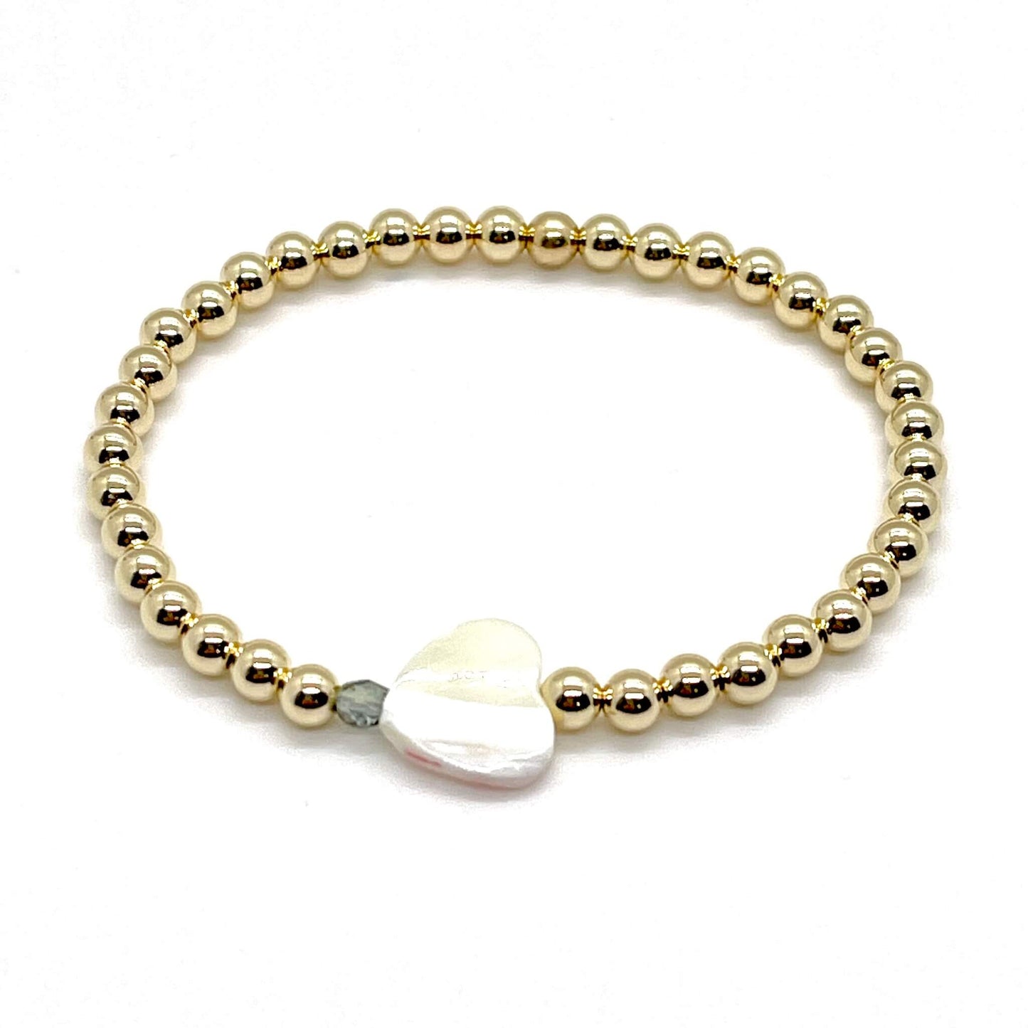 Gold heart bracelet with a mother-of-pearl heart, a small faceted green-grey crystal, and 4mm 14K gold filled beads.