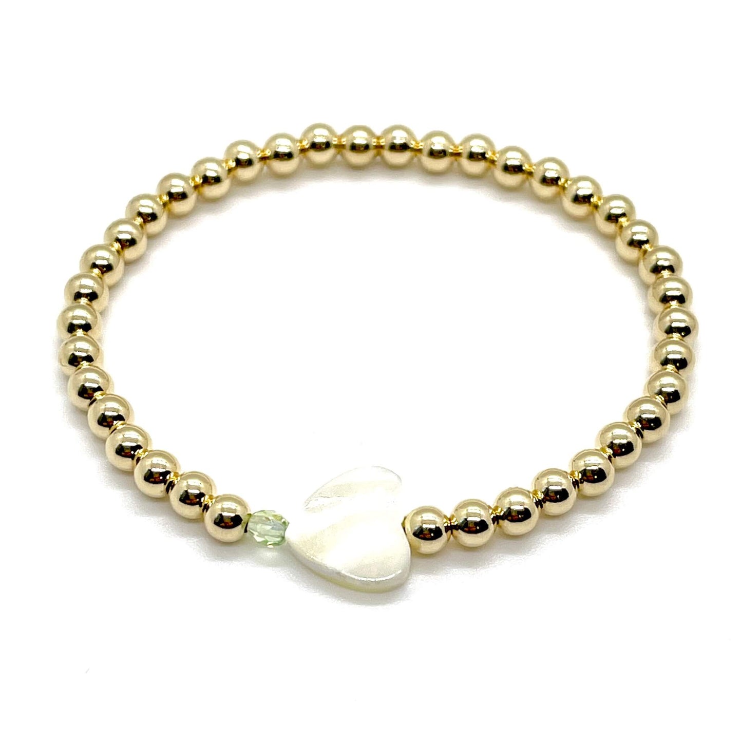 Gold heart bracelet with a mother-of-pearl heart, a small faceted green crystal, and 4mm 14K gold filled beads.