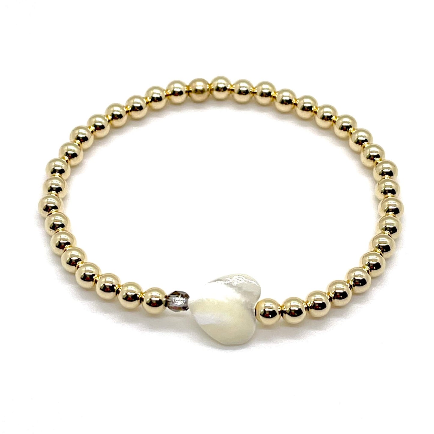 Gold heart bracelet with a mother-of-pearl heart, a small faceted grey-silver crystal, and 4mm 14K gold filled beads.