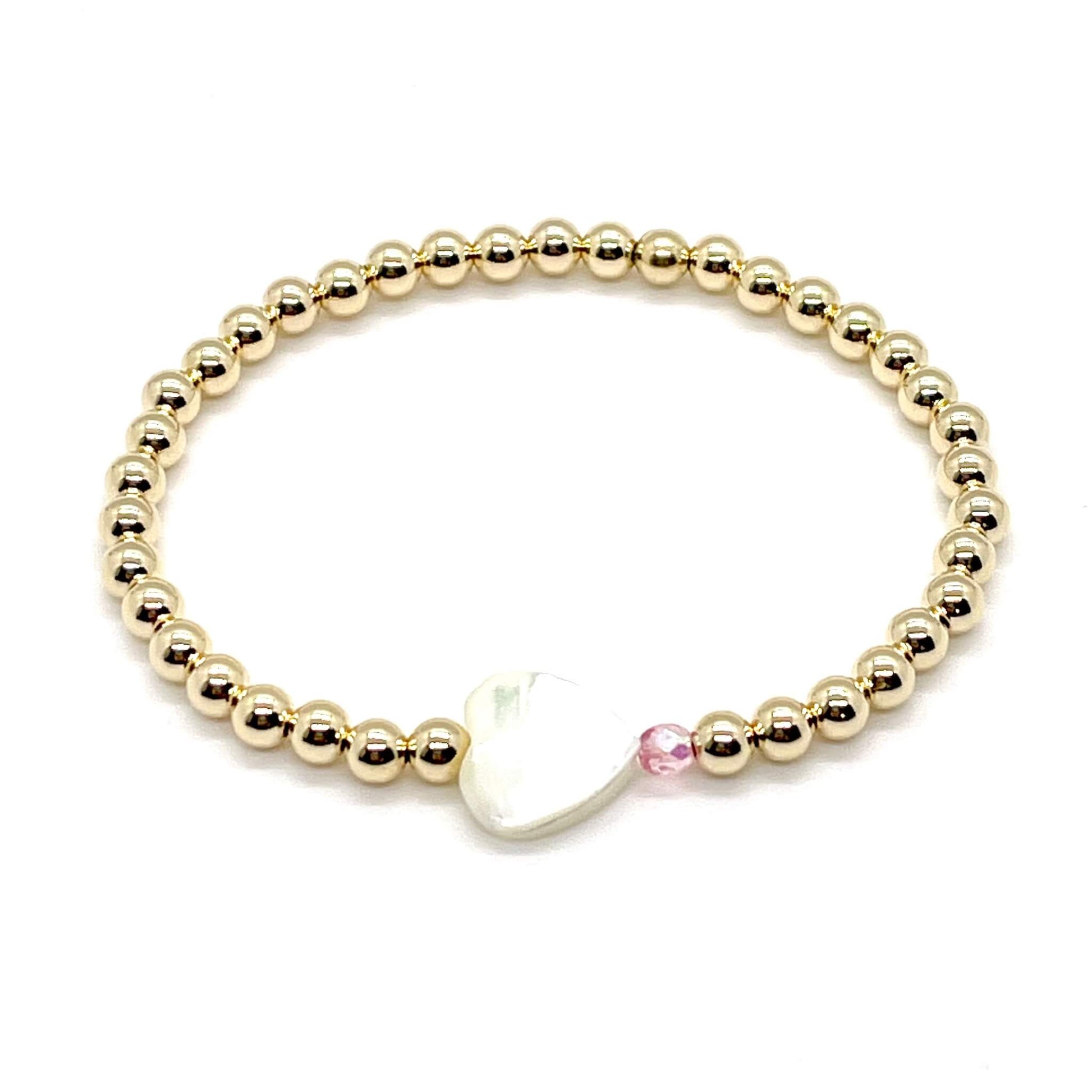 Gold heart bracelet with a mother-of-pearl heart, a small faceted pink crystal, and 4mm 14K gold filled beads.