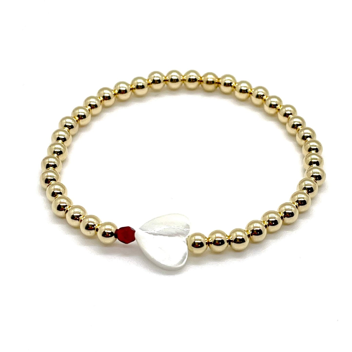 Gold heart bracelet with a mother-of-pearl heart, a small faceted red crystal, and 4mm 14K gold filled beads.