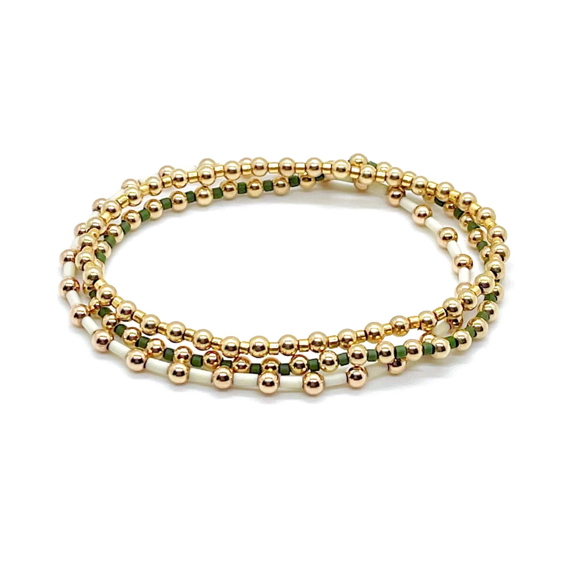 Delicate handmade 14K gold filled stretch bracelets with alternating green and ivory tiny glass seed beads.
