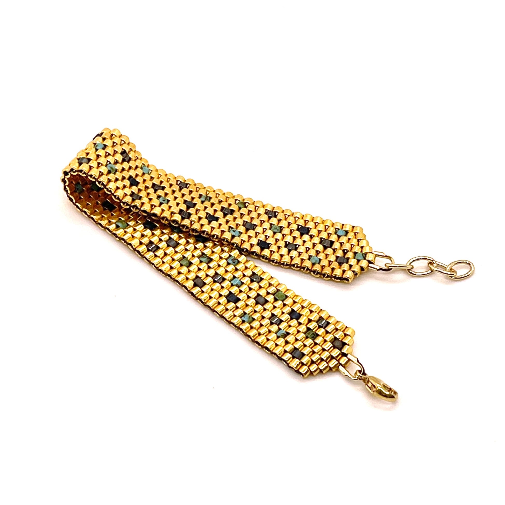 Gold seed bead handwoven bracelet with turquoise and gunmetal sprinkled accent beads.