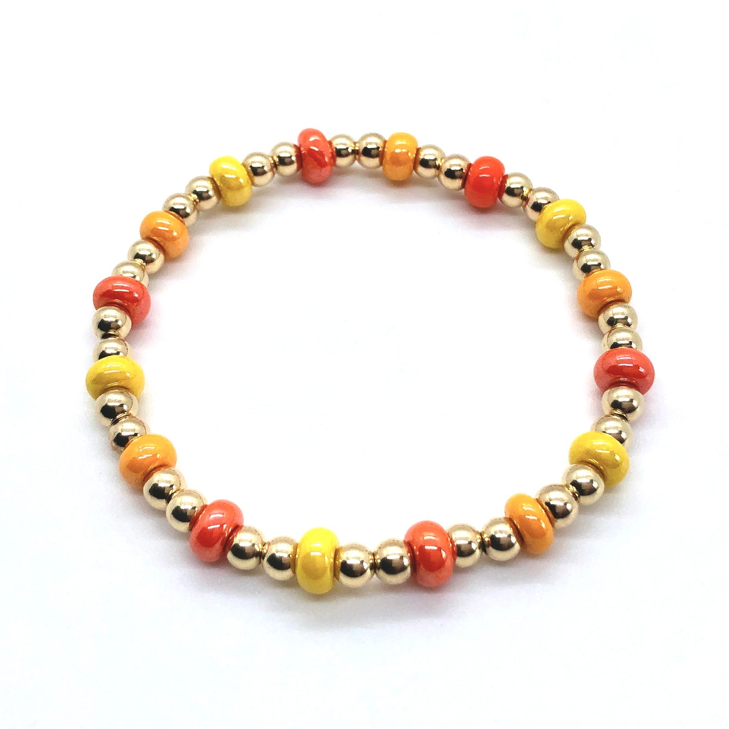 4mm gold ball stretch bracelet with alternating orange and yellow beads on elastic stretch cord.
