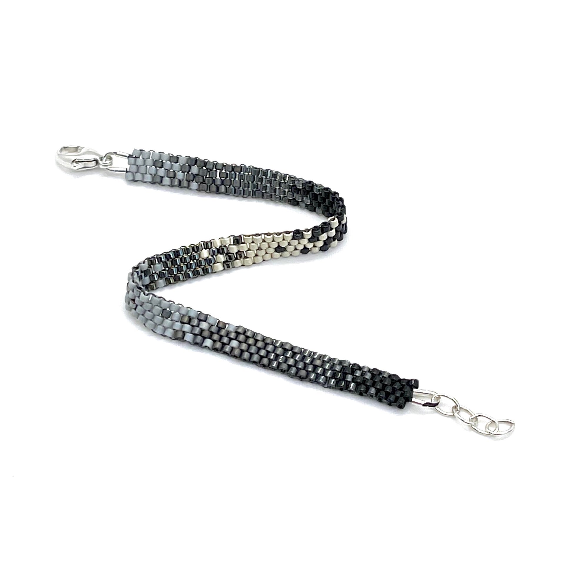 Gray and black ombre beaded flat woven bracelet with seed beads and a sterling silver lobster clasp.
